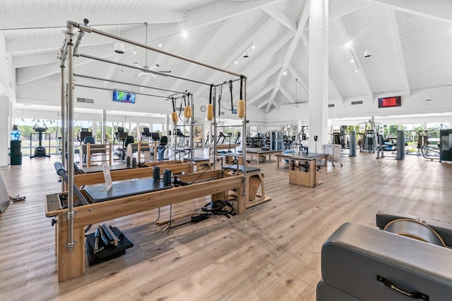 gym featuring ceiling fan, hardwood / wood-style floors, high vaulted ceiling, and wooden ceiling