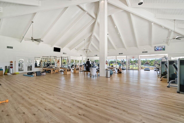 gym featuring french doors, light hardwood / wood-style floors, high vaulted ceiling, and ceiling fan