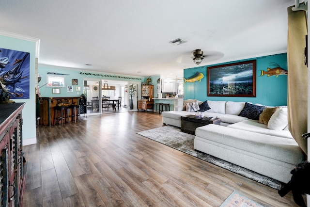 living room with ornamental molding, ceiling fan, and hardwood / wood-style flooring