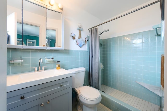 bathroom featuring walk in shower, tile walls, vanity, and toilet