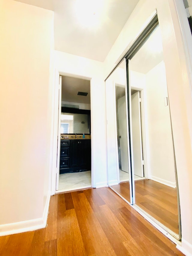 unfurnished bedroom with a closet and hardwood / wood-style floors