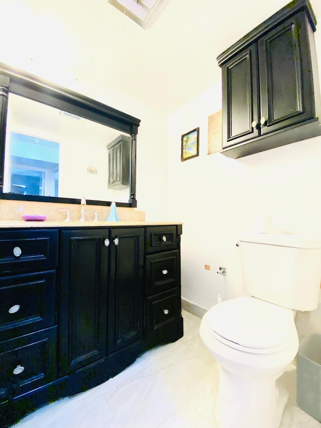 bathroom featuring tile flooring, toilet, and large vanity