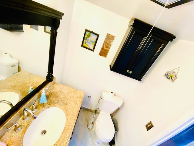 bathroom featuring vanity, toilet, and tile floors