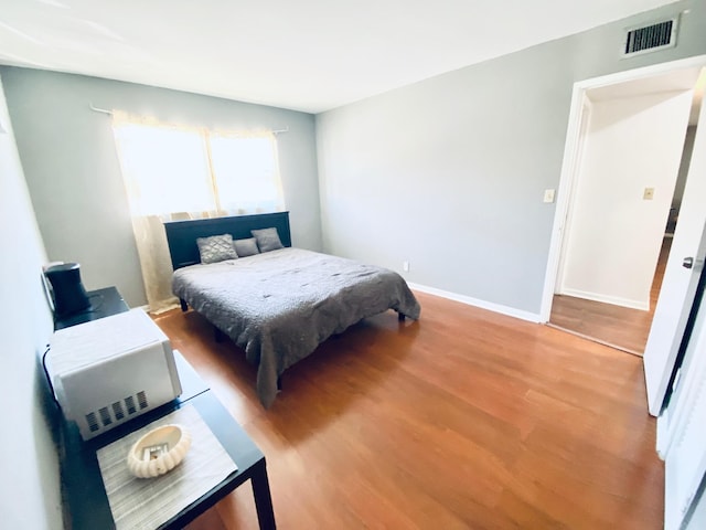 bedroom featuring wood-type flooring