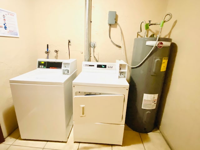 clothes washing area featuring washing machine and dryer, washer hookup, water heater, and light tile floors