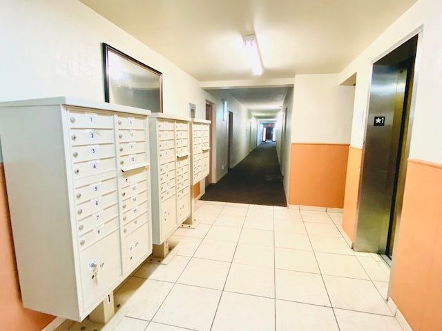 corridor with light tile floors, a mail area, and elevator