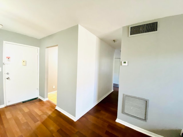 hall with hardwood / wood-style floors