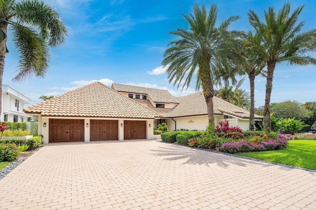 mediterranean / spanish house with a garage