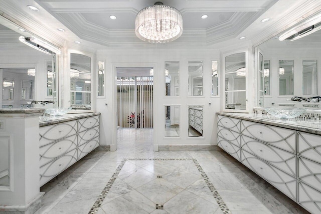 bathroom with vanity, a tray ceiling, crown molding, and a notable chandelier