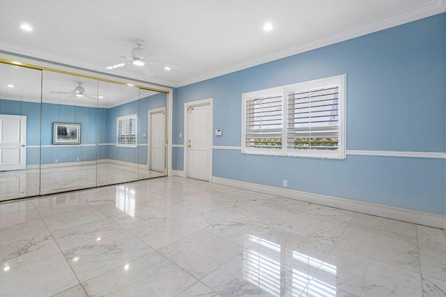 empty room featuring ceiling fan and ornamental molding