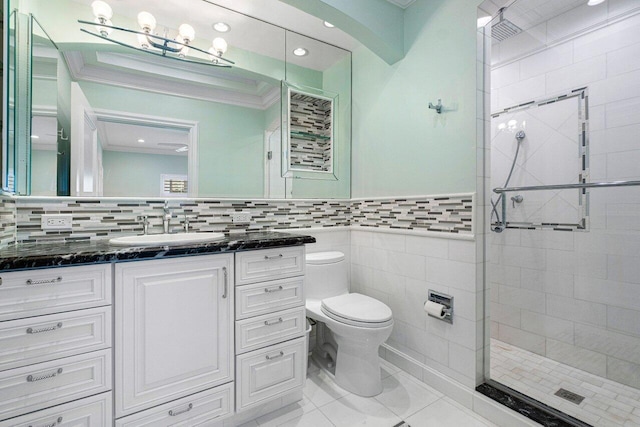 bathroom featuring vanity, tile patterned floors, toilet, ornamental molding, and an enclosed shower