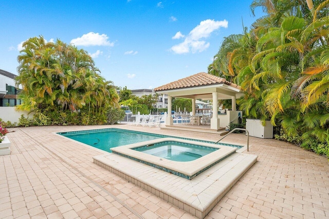 view of swimming pool with an in ground hot tub, a gazebo, and a patio area