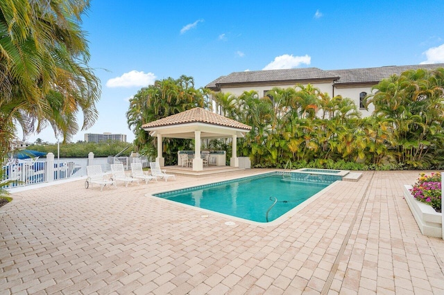 view of swimming pool with a gazebo, a patio area, and an in ground hot tub