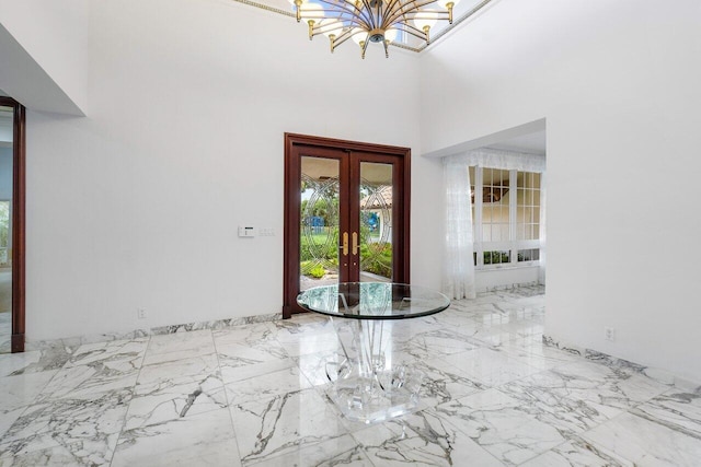 entryway with a chandelier and french doors