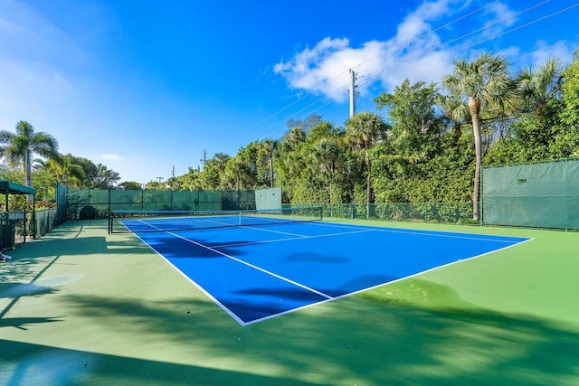 view of tennis court with basketball hoop