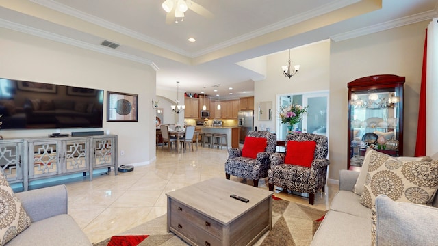 tiled living room with ornamental molding, ceiling fan with notable chandelier, and a raised ceiling