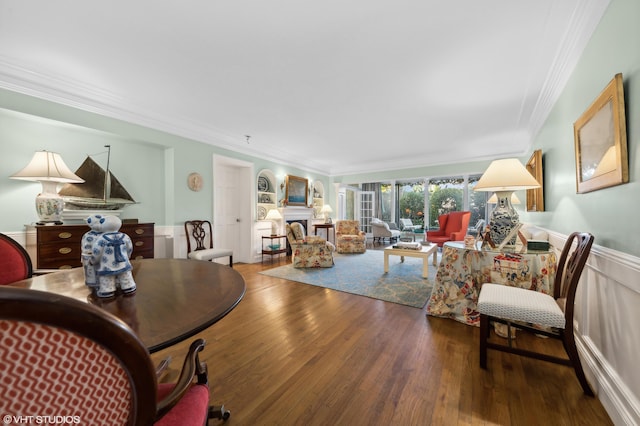 living room with wood-type flooring and ornamental molding