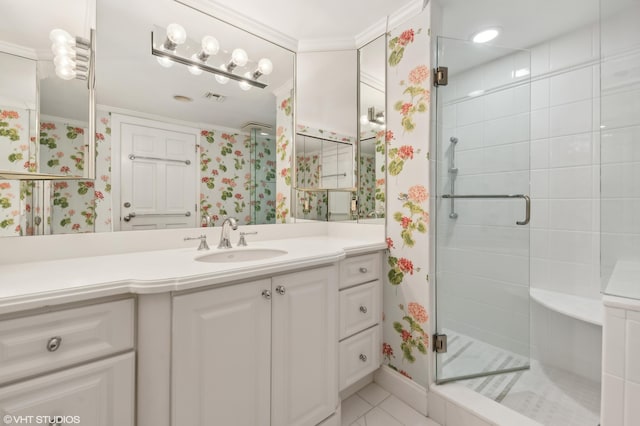 bathroom featuring tile flooring, a shower with shower door, ornamental molding, and vanity