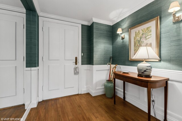 foyer with ornamental molding and wood-type flooring