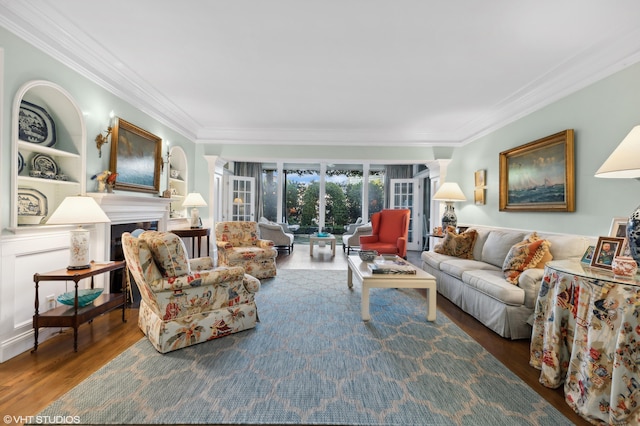 living room with wood-type flooring, a fireplace, and crown molding