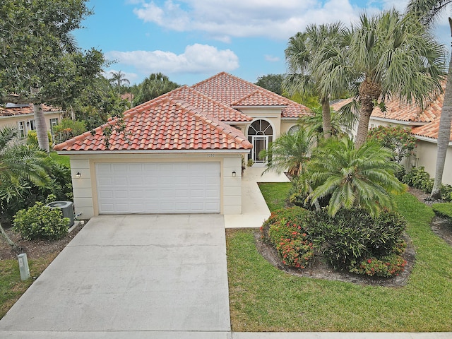 mediterranean / spanish-style house with a garage and a front yard