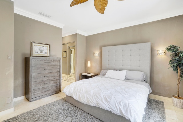 tiled bedroom featuring ornamental molding and ceiling fan