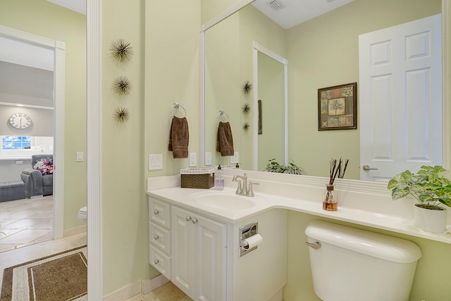 bathroom featuring vanity, toilet, and tile patterned flooring