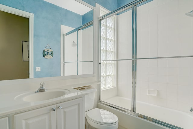 full bathroom with vanity, toilet, and bath / shower combo with glass door