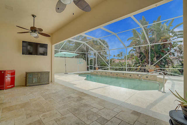 view of swimming pool featuring ceiling fan, a patio area, and glass enclosure