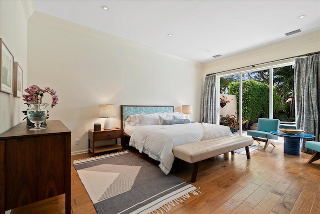 bedroom featuring wood-type flooring and ornamental molding