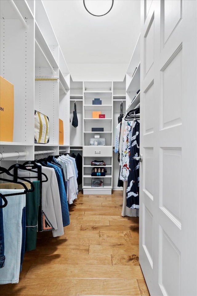 spacious closet with light hardwood / wood-style floors