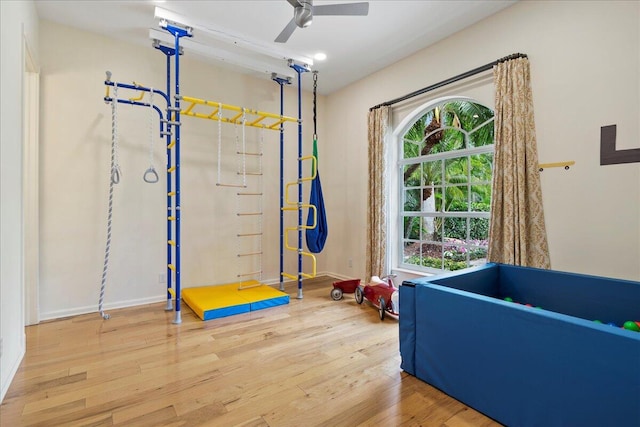 recreation room with hardwood / wood-style flooring and ceiling fan