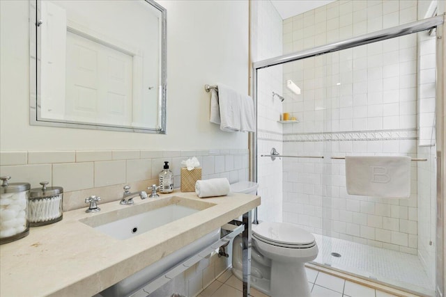 bathroom featuring tile walls, tasteful backsplash, tile floors, sink, and walk in shower