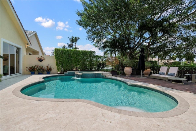 view of pool with an in ground hot tub and a patio