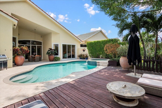 view of swimming pool with an in ground hot tub and a deck