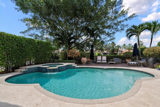 view of swimming pool featuring an in ground hot tub and a patio