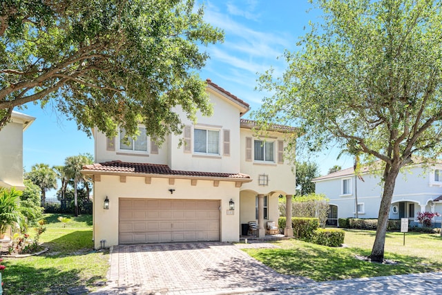 mediterranean / spanish home with a front lawn and a garage