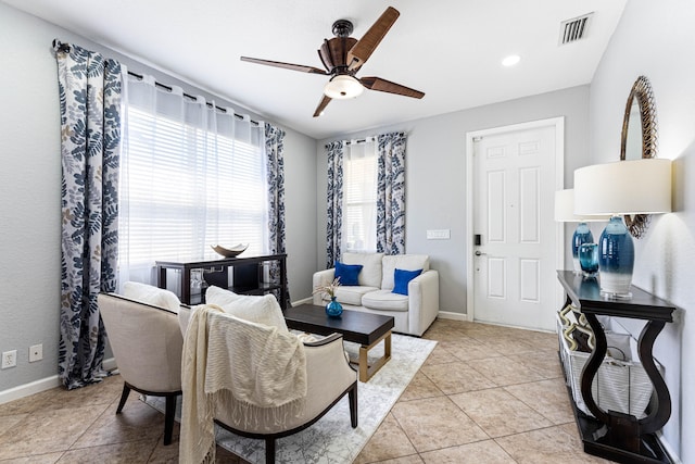 tiled dining space with ceiling fan