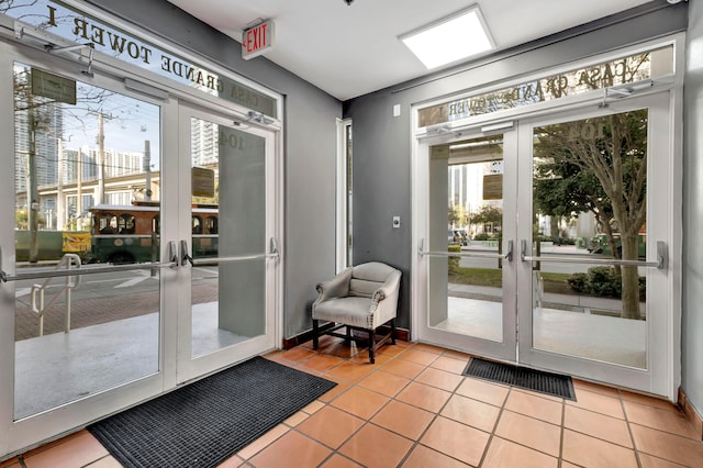 doorway featuring a healthy amount of sunlight, french doors, and light tile flooring