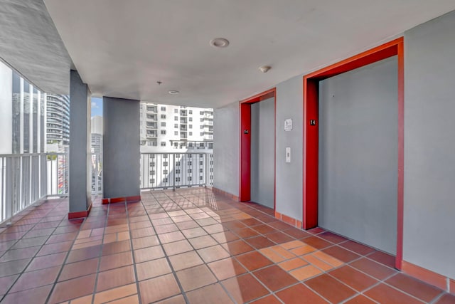 interior space with elevator and a balcony