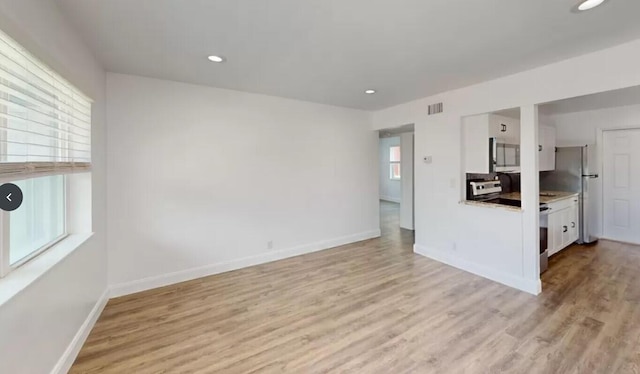 unfurnished living room featuring light wood-type flooring