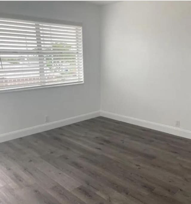 spare room with dark hardwood / wood-style floors