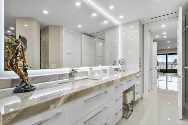 bathroom with tile floors and double vanity