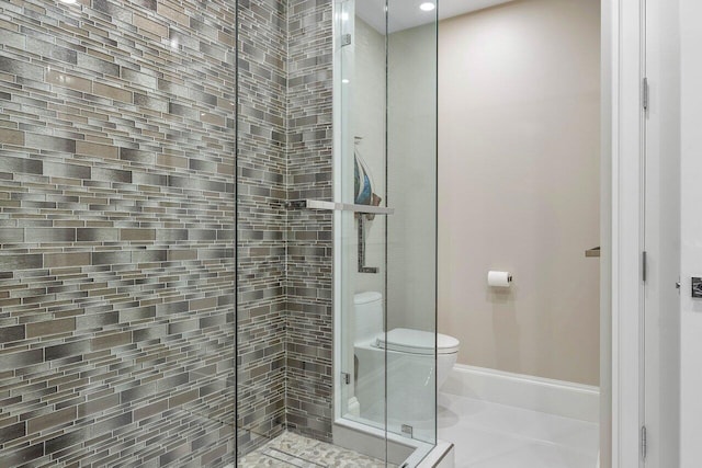 bathroom with a shower with door, tile flooring, and toilet