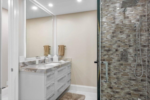 bathroom with a shower with door and vanity