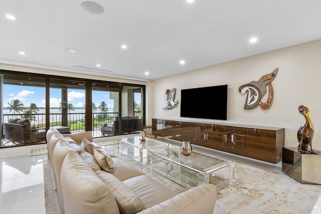 living room with tile flooring, french doors, and floor to ceiling windows