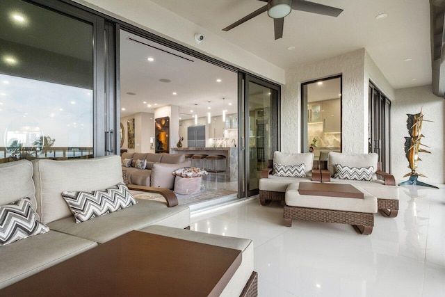 living room featuring ceiling fan and tile floors