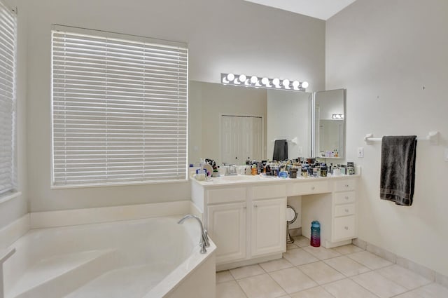 bathroom with a bath, tile floors, and large vanity