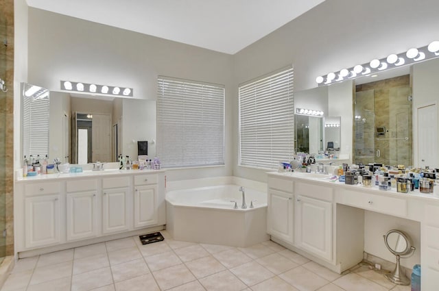 bathroom with shower with separate bathtub, oversized vanity, double sink, and tile floors