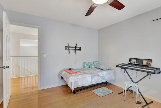 bedroom with ceiling fan and light hardwood / wood-style flooring